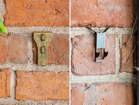 mounting metal bracket on brick exterior|hanging sticks on brick walls.